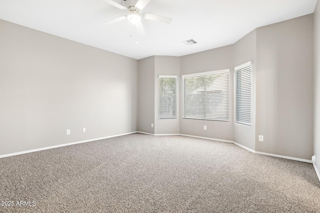 carpeted empty room featuring ceiling fan