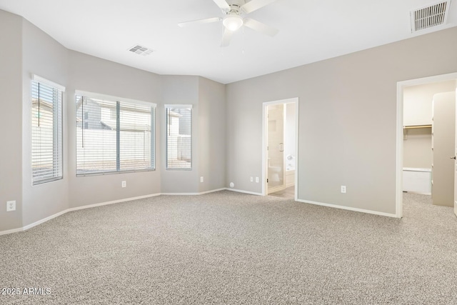 carpeted spare room featuring ceiling fan and a wealth of natural light