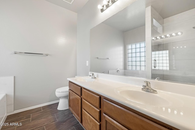 full bathroom featuring independent shower and bath, vanity, and toilet