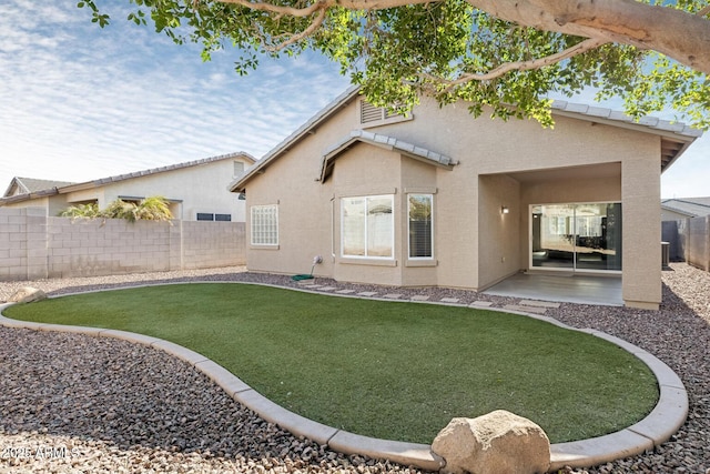 rear view of property with a patio and a lawn