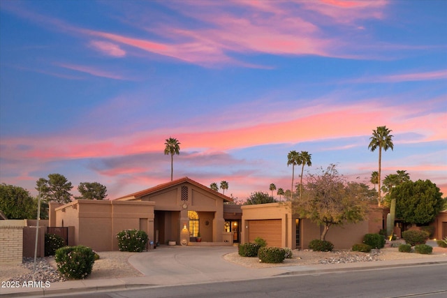 6208 E Paradise Ln, Scottsdale, AZ 85254 - view of front of home featuring curved driveway, a garage, and stucco siding