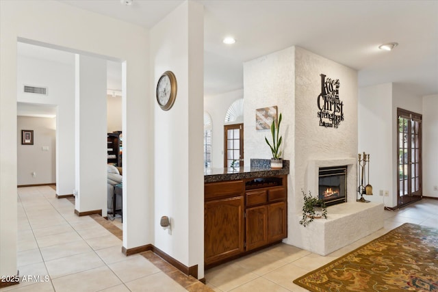 6208 E Paradise Ln, Scottsdale, AZ 85254 - hallway with light tile patterned floors, visible vents, baseboards, and a healthy amount of sunlight