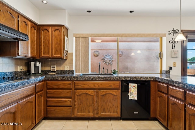 6208 E Paradise Ln, Scottsdale, AZ 85254 - kitchen featuring a sink, brown cabinets, black appliances, backsplash, and pendant lighting