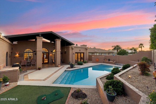 6208 E Paradise Ln, Scottsdale, AZ 85254 - view of swimming pool with french doors, a fenced backyard, a fenced in pool, and a patio