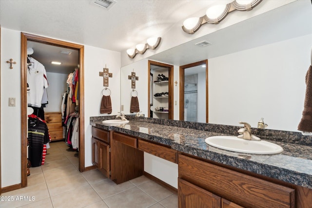 6208 E Paradise Ln, Scottsdale, AZ 85254 - full bathroom featuring a spacious closet, a sink, tile patterned flooring, and visible vents