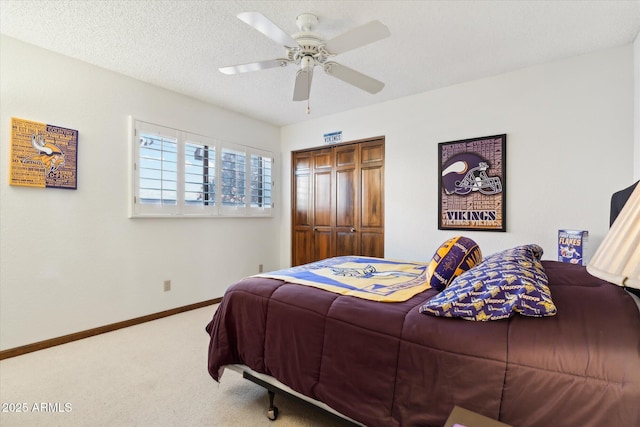 6208 E Paradise Ln, Scottsdale, AZ 85254 - carpeted bedroom with a textured ceiling, a closet, baseboards, and a ceiling fan