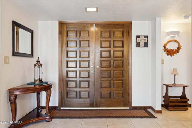 6208 E Paradise Ln, Scottsdale, AZ 85254 - foyer with light tile patterned floors, baseboards, and a textured ceiling