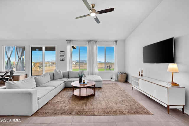 28435 N 249th Ln, Wittmann, AZ 85361 - living area with plenty of natural light, ceiling fan, lofted ceiling, tile patterned flooring, and baseboards