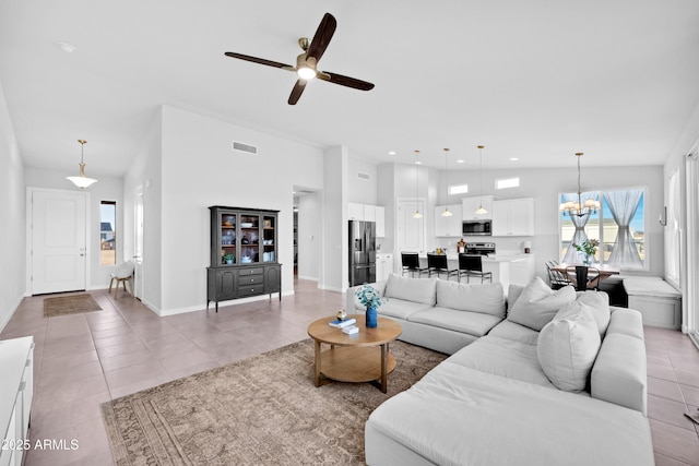 28435 N 249th Ln, Wittmann, AZ 85361 - living room featuring a chandelier, light tile patterned flooring, a ceiling fan, baseboards, and recessed lighting