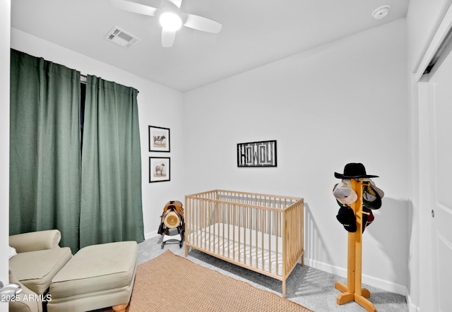 28435 N 249th Ln, Wittmann, AZ 85361 - bedroom with carpet, a crib, baseboards, and ceiling fan