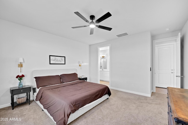 28435 N 249th Ln, Wittmann, AZ 85361 - bedroom featuring light carpet, baseboards, ceiling fan, and ensuite bath