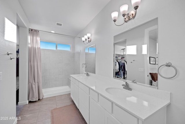 28435 N 249th Ln, Wittmann, AZ 85361 - bathroom featuring a chandelier, double vanity, tiled shower, tile patterned flooring, and recessed lighting