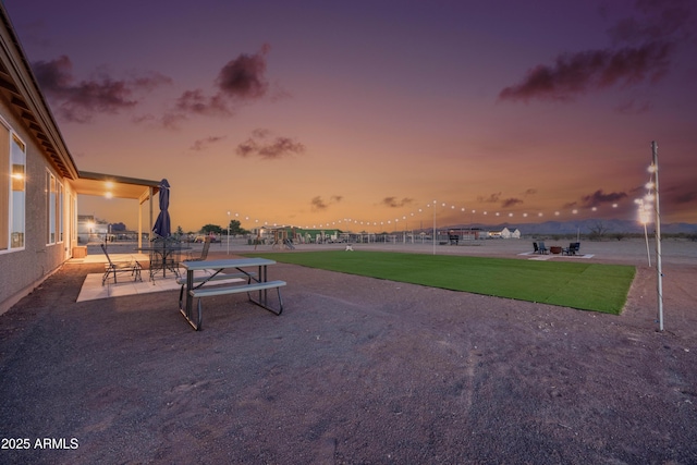 28435 N 249th Ln, Wittmann, AZ 85361 - patio terrace at dusk featuring a patio area