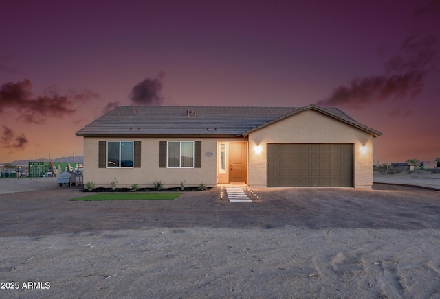 28435 N 249th Ln, Wittmann, AZ 85361 - ranch-style home with a garage, dirt driveway, a tiled roof, and stucco siding