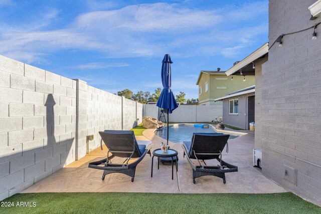 view of patio with a fenced in pool