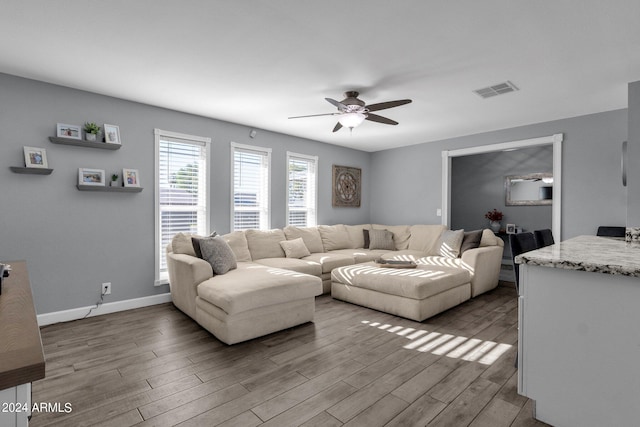 living room with ceiling fan and light wood-type flooring