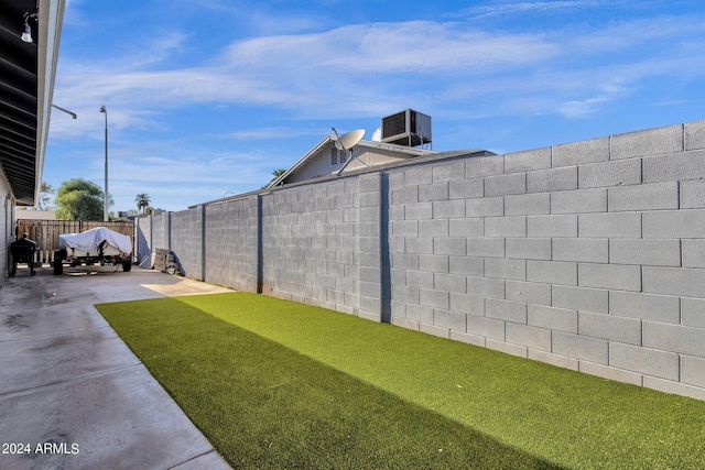 view of yard featuring a patio and central AC