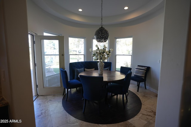 dining space featuring a raised ceiling