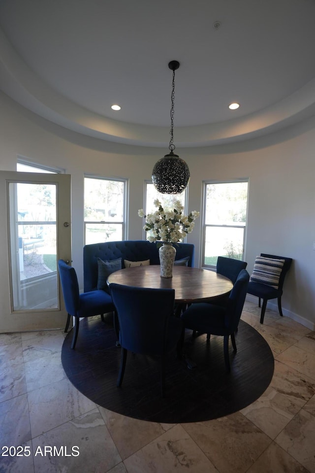 dining space with a tray ceiling