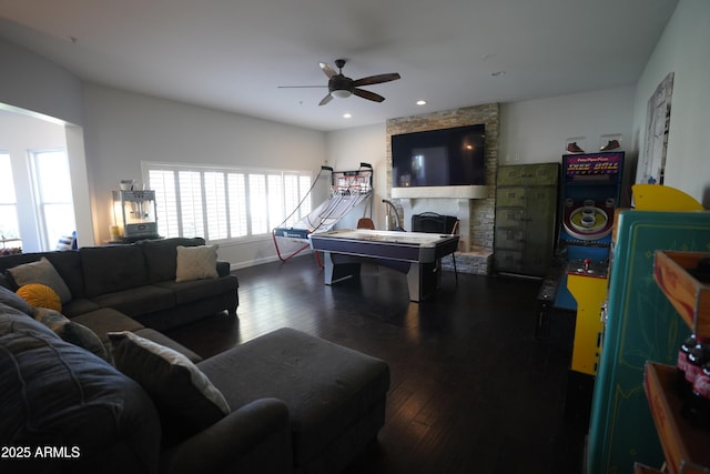 playroom with ceiling fan, a fireplace, and dark hardwood / wood-style flooring