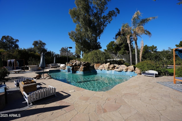 view of swimming pool with a patio area, an outdoor living space, and pool water feature