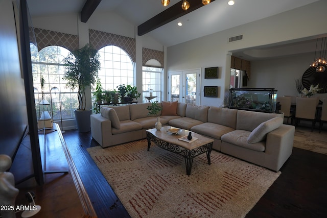 living room with an inviting chandelier, dark hardwood / wood-style flooring, a healthy amount of sunlight, and vaulted ceiling with beams