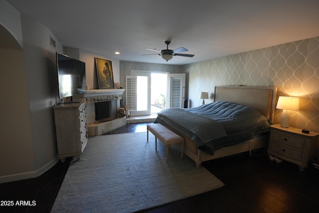 bedroom with ceiling fan and dark hardwood / wood-style floors