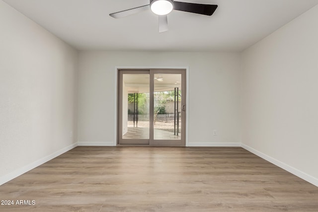 spare room featuring ceiling fan and light hardwood / wood-style flooring