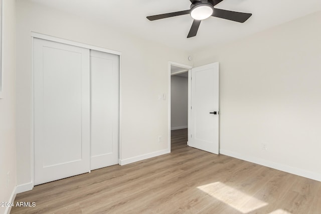 unfurnished bedroom with a closet, ceiling fan, and light hardwood / wood-style flooring