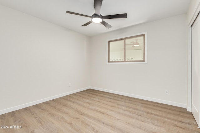 spare room with ceiling fan and light wood-type flooring