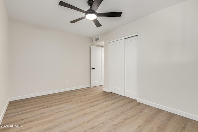 unfurnished bedroom featuring ceiling fan, a closet, and light hardwood / wood-style floors