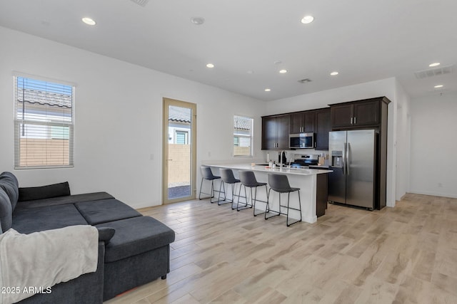 3885 E Kenley Ln, San Tan Valley, AZ 85143 - living area featuring light wood-type flooring, recessed lighting, and baseboards