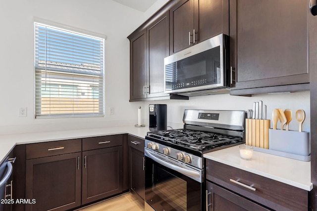 3885 E Kenley Ln, San Tan Valley, AZ 85143 - kitchen featuring stainless steel appliances, dark brown cabinets, and light countertops