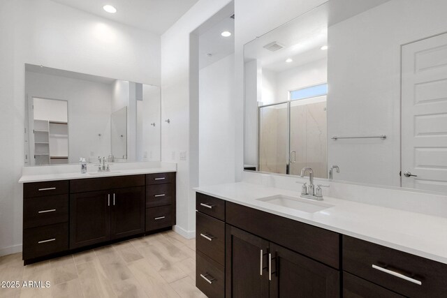 3885 E Kenley Ln, San Tan Valley, AZ 85143 - full bath with a stall shower, baseboards, two vanities, and recessed lighting