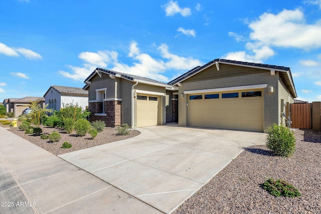 3885 E Kenley Ln, San Tan Valley, AZ 85143 - view of front of home with a garage, concrete driveway, stucco siding, a gate, and a tile roof