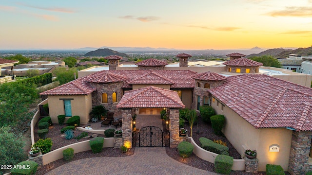 4328 N Pinnacle Ridge Cir, Mesa, AZ 85207 - mediterranean / spanish house featuring stucco siding, a tiled roof, a mountain view, and stone siding