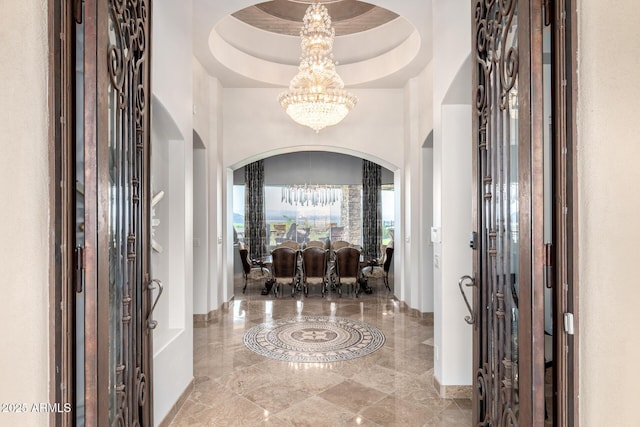 4328 N Pinnacle Ridge Cir, Mesa, AZ 85207 - foyer entrance featuring arched walkways, a chandelier, marble tiled floors, a raised ceiling, and baseboards