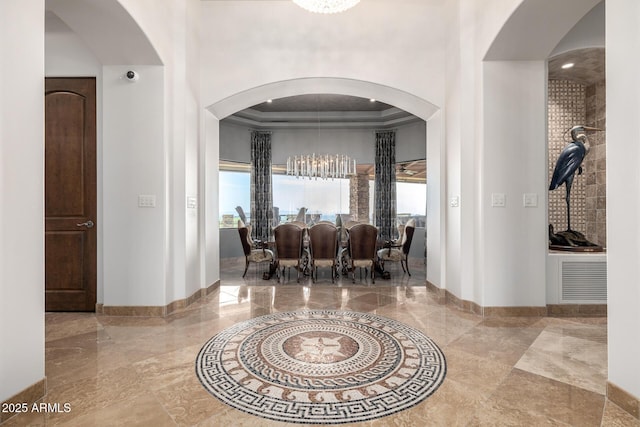 4328 N Pinnacle Ridge Cir, Mesa, AZ 85207 - foyer entrance with a tray ceiling, baseboards, marble tiled flooring, arched walkways, and ornamental molding