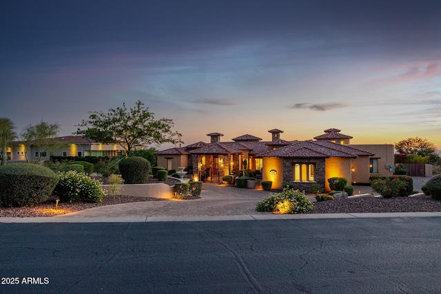4328 N Pinnacle Ridge Cir, Mesa, AZ 85207 - mediterranean / spanish-style house with curved driveway, stucco siding, and stone siding