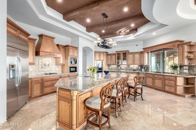 4328 N Pinnacle Ridge Cir, Mesa, AZ 85207 - kitchen featuring built in fridge, open shelves, custom range hood, a chandelier, and brown cabinets