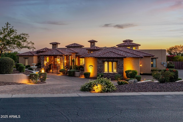 4328 N Pinnacle Ridge Cir, Mesa, AZ 85207 - mediterranean / spanish-style house featuring stone siding, curved driveway, stucco siding, and a tile roof