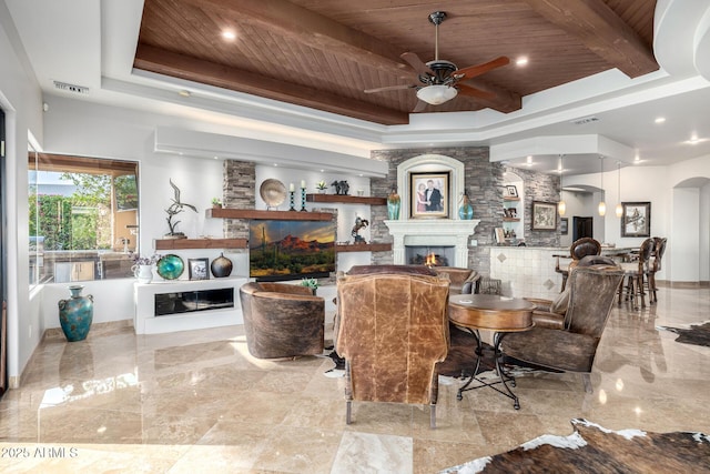 4328 N Pinnacle Ridge Cir, Mesa, AZ 85207 - living area with wood ceiling with exposed beams, a warm lit fireplace, ceiling fan, a raised ceiling, and arched walkways