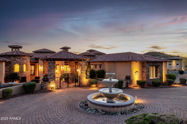 4328 N Pinnacle Ridge Cir, Mesa, AZ 85207 - view of front facade with stone siding, curved driveway, a tile roof, and stucco siding