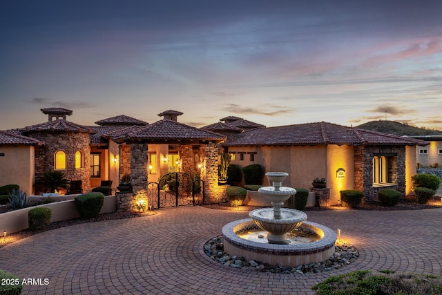 4328 N Pinnacle Ridge Cir, Mesa, AZ 85207 - view of front of home featuring stone siding, curved driveway, and a tiled roof