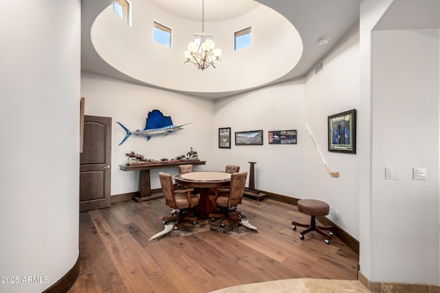 4328 N Pinnacle Ridge Cir, Mesa, AZ 85207 - dining space with a towering ceiling, a chandelier, wood finished floors, and baseboards