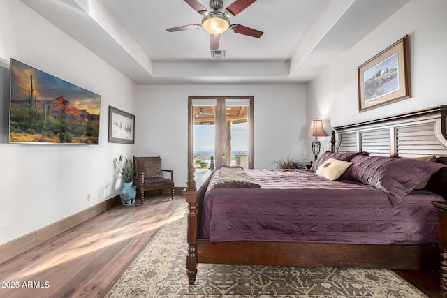 4328 N Pinnacle Ridge Cir, Mesa, AZ 85207 - bedroom with a tray ceiling, wood finished floors, baseboards, ceiling fan, and access to exterior