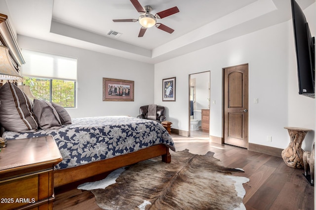 4328 N Pinnacle Ridge Cir, Mesa, AZ 85207 - bedroom with a tray ceiling, wood finished floors, baseboards, connected bathroom, and ceiling fan