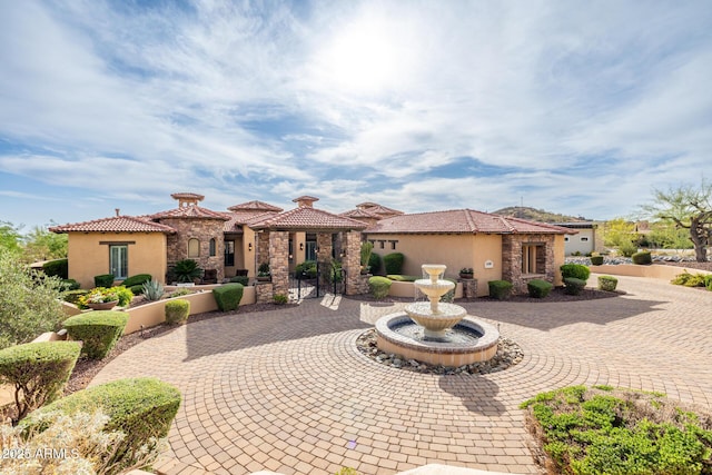 4328 N Pinnacle Ridge Cir, Mesa, AZ 85207 - mediterranean / spanish home with stone siding, stucco siding, and curved driveway