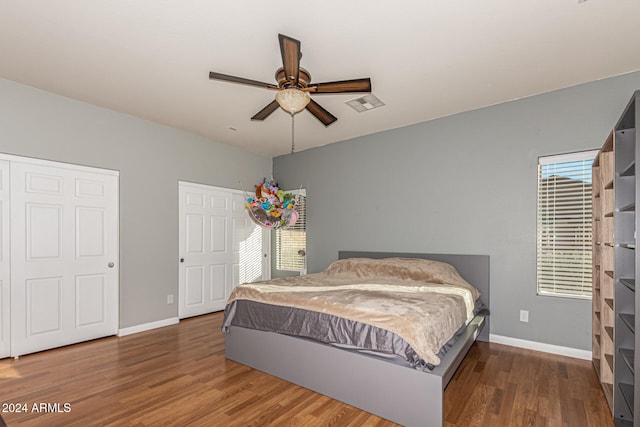 bedroom with ceiling fan and dark hardwood / wood-style flooring