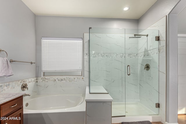 bathroom featuring vanity and separate shower and tub